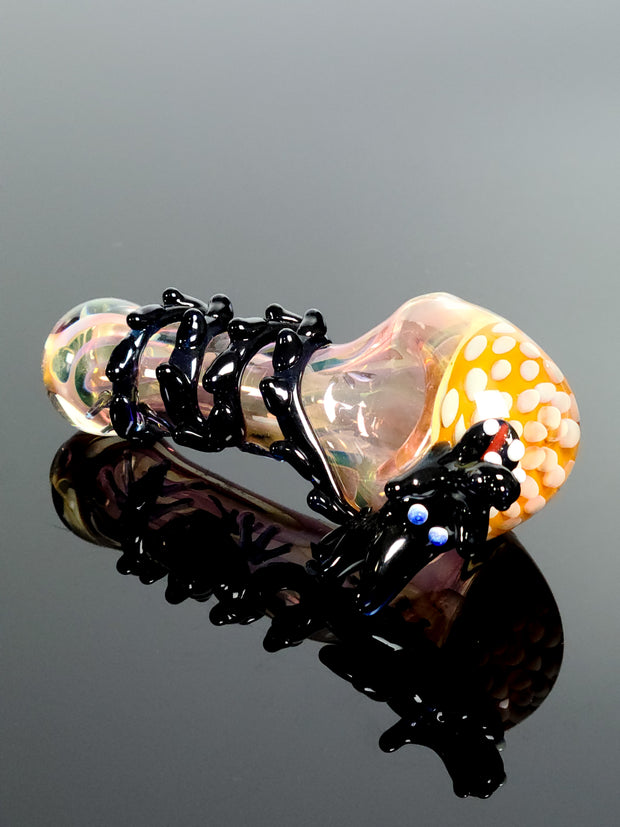 Pink glass spoon with black dragon with blown in puffs