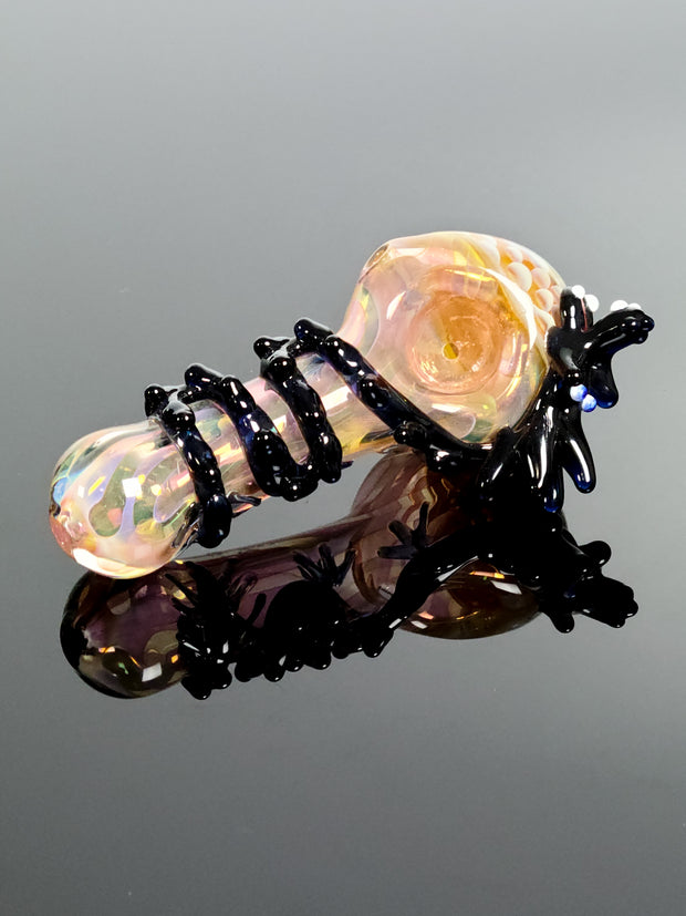Pink glass spoon with black dragon with blown in puffs