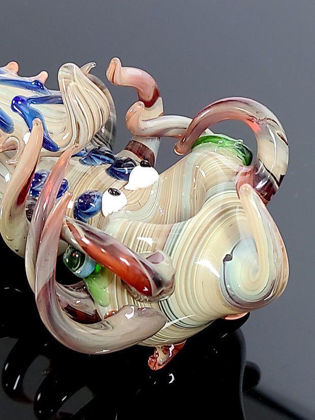 Creature pipe with swirls and tentacles